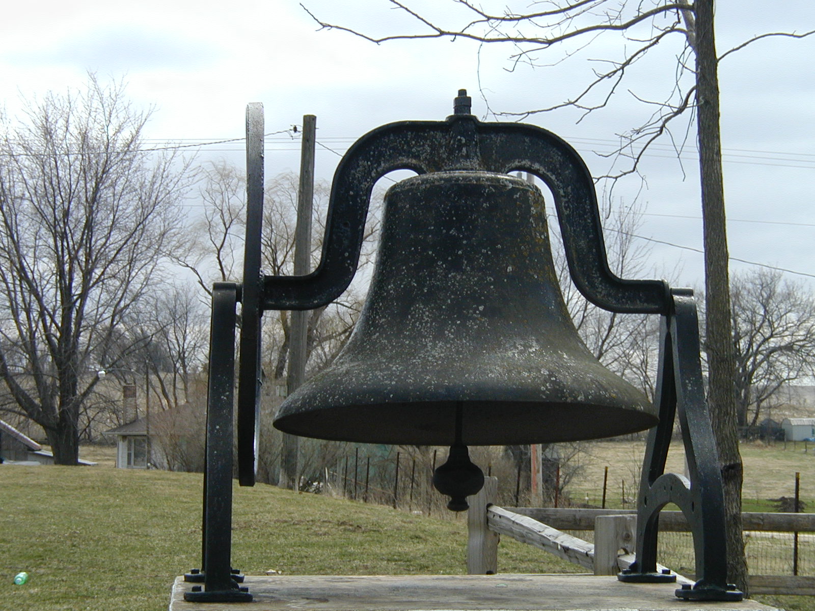 Bell mounted on stand near the old church on the Massillon cemetery grounds